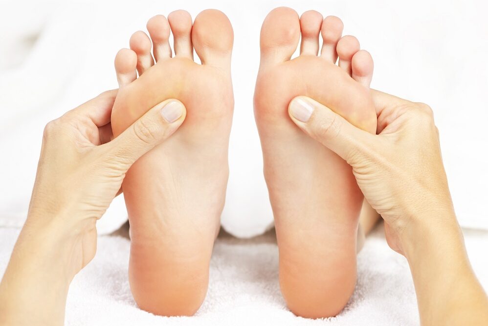 Female,Hands,Giving,Massage,To,Soft,Bare,Feet