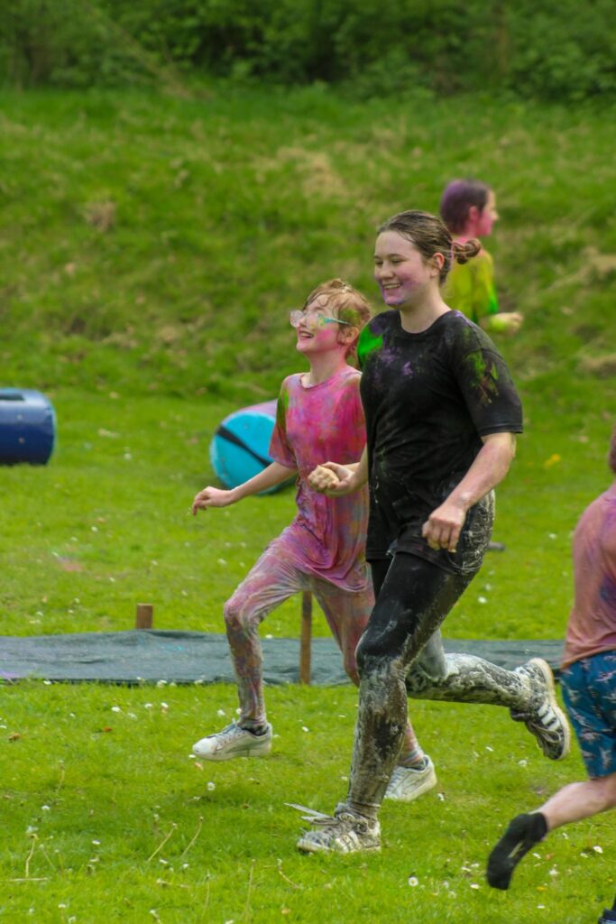 children and teachers running and laughing